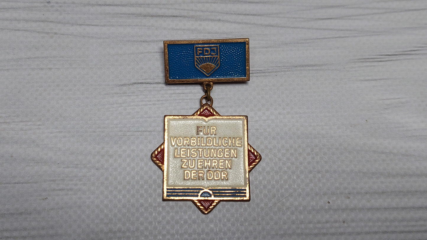 Vintage "Excellent Achievement" badge for the East German GDR medal.