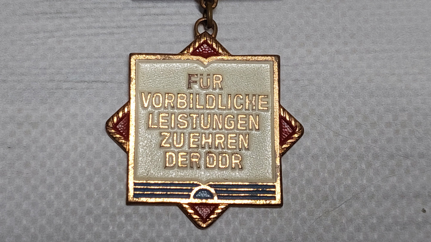 Vintage "Excellent Achievement" badge for the East German GDR medal.