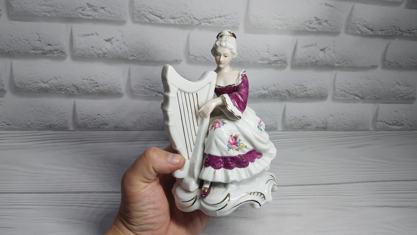 Porcelain vintage romanian figurine girl with alpha.