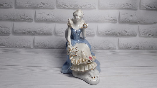 Porcelain vintage romanian figurine girl with flower.