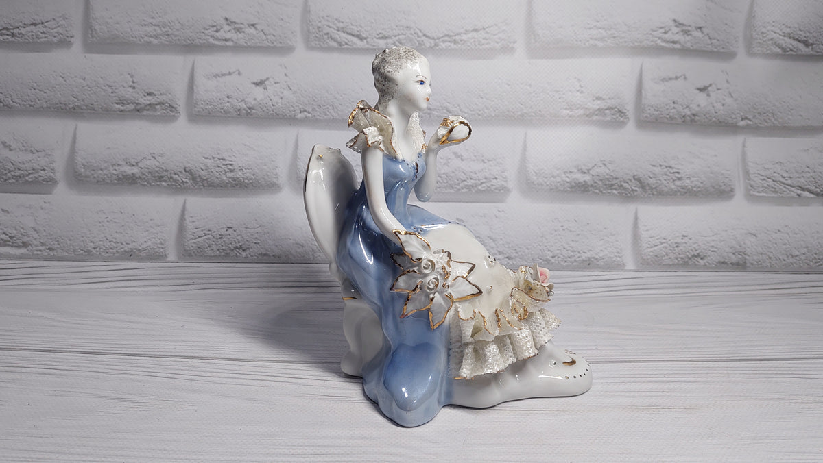 Porcelain vintage romanian figurine girl with flower.