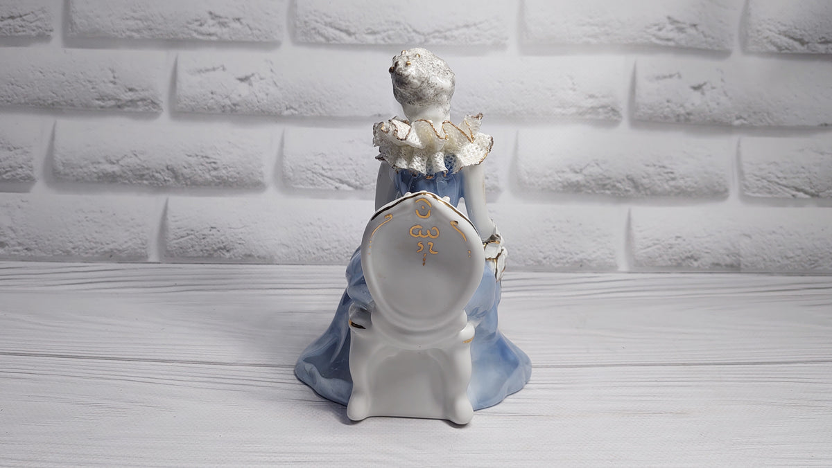Porcelain vintage romanian figurine girl with flower.