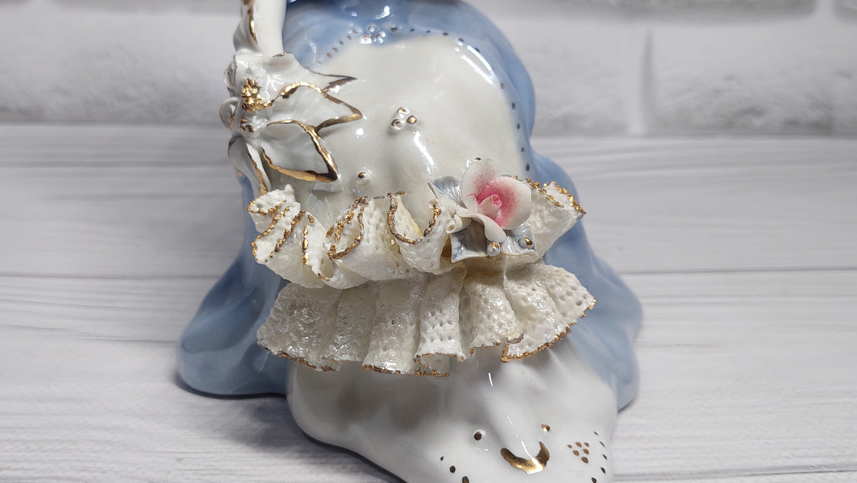 Porcelain vintage romanian figurine girl with flower.
