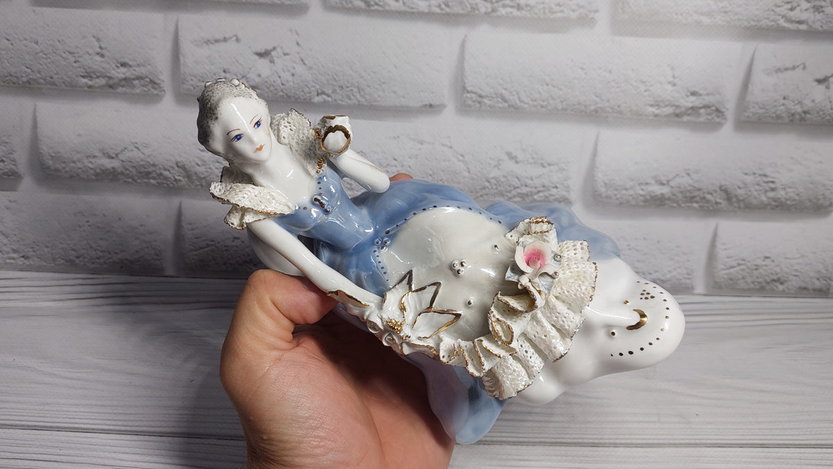 Porcelain vintage romanian figurine girl with flower.