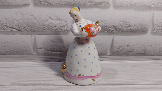 Porcelain figurine of a girl with a teapot and a cat