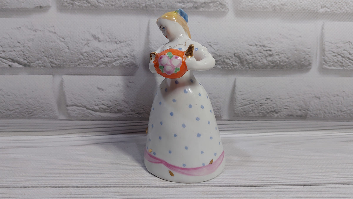 Porcelain figurine of a girl with a teapot and a cat