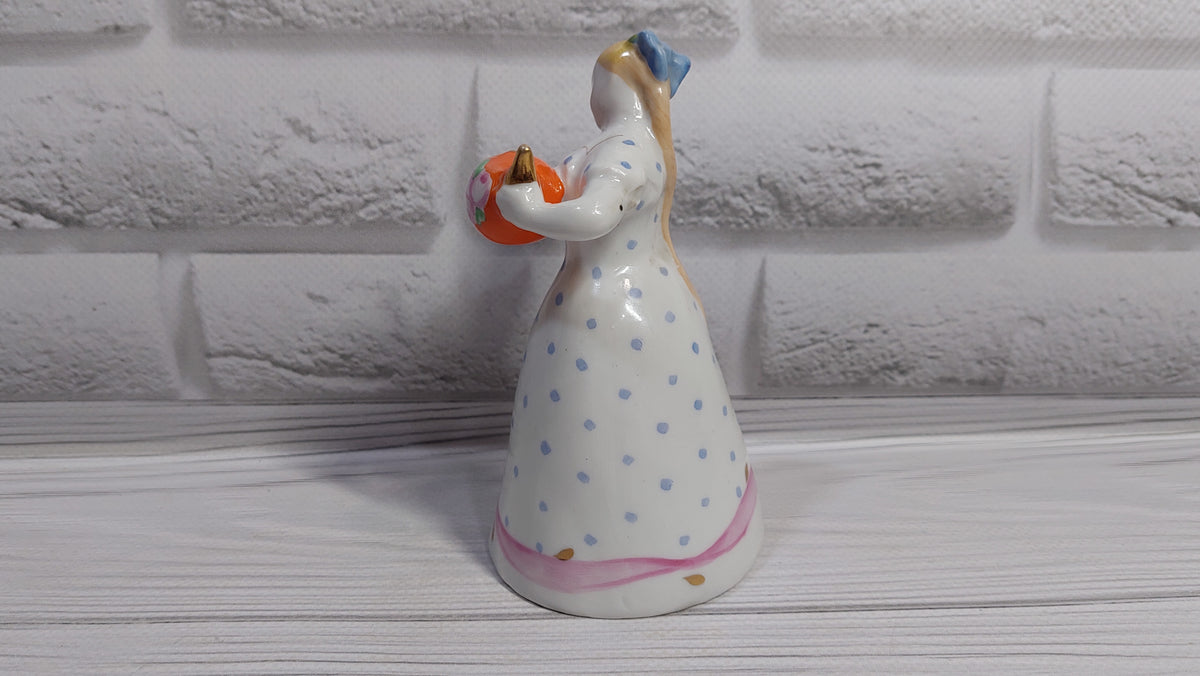 Porcelain figurine of a girl with a teapot and a cat