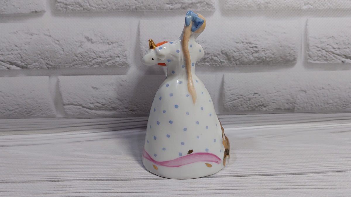 Porcelain figurine of a girl with a teapot and a cat