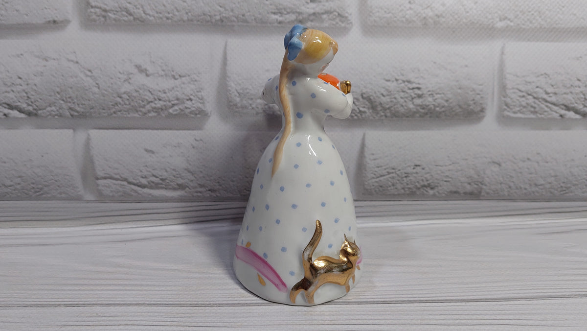 Porcelain figurine of a girl with a teapot and a cat