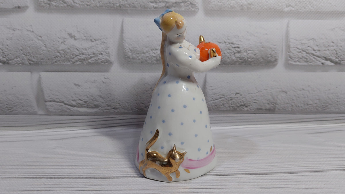 Porcelain figurine of a girl with a teapot and a cat