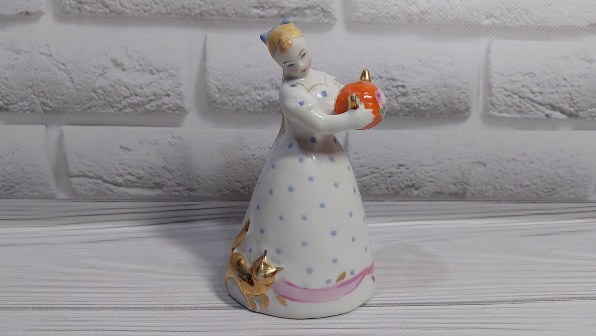 Porcelain figurine of a girl with a teapot and a cat