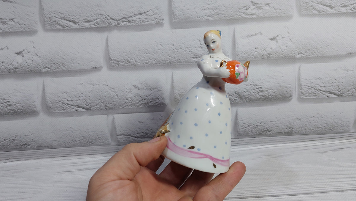 Porcelain figurine of a girl with a teapot and a cat