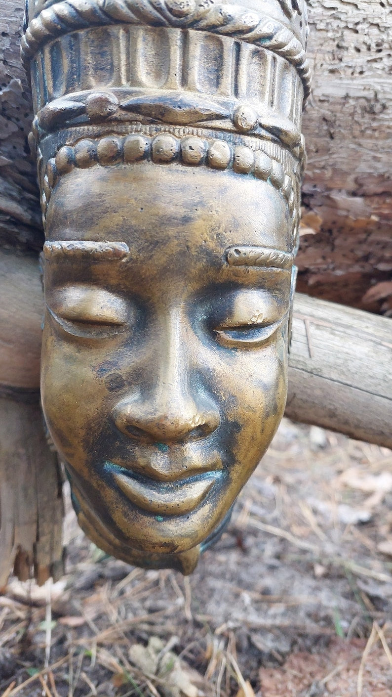 Buddha mask. Bronze buddha mask