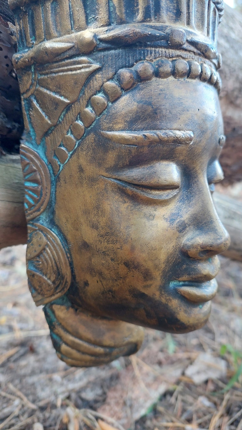 Buddha mask. Bronze buddha mask