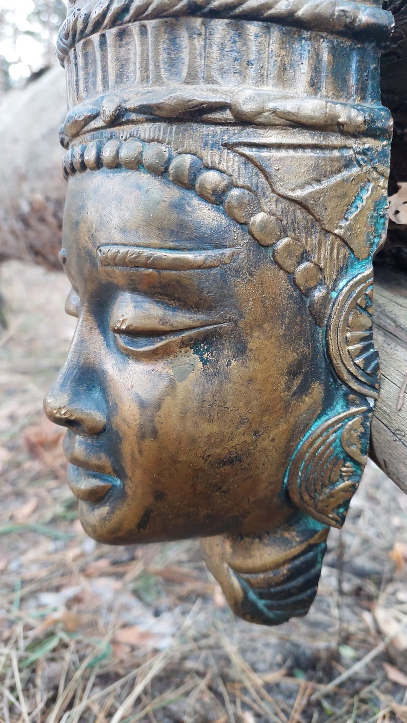 Buddha mask. Bronze buddha mask