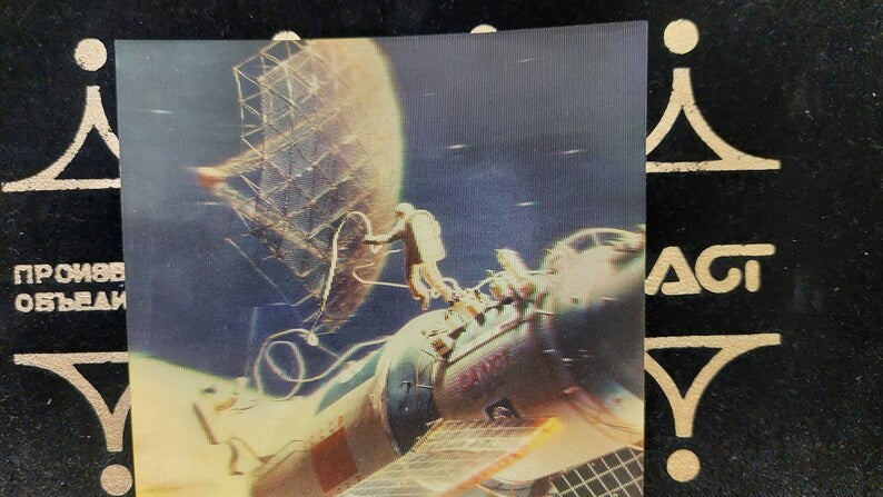 Postcard 3d. Astronauts in outer space. Orbital complex Salyut-Soyuz