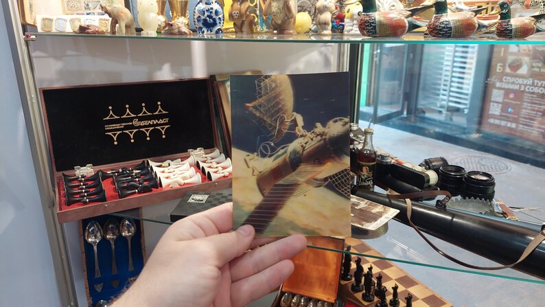 Postcard 3d. Astronauts in outer space. Orbital complex Salyut-Soyuz