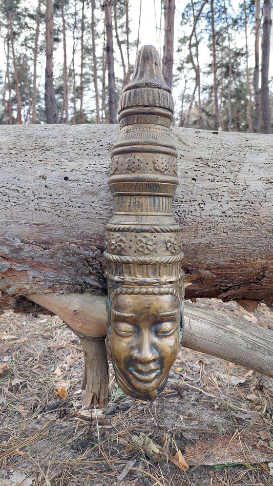 Buddha mask. Bronze buddha mask